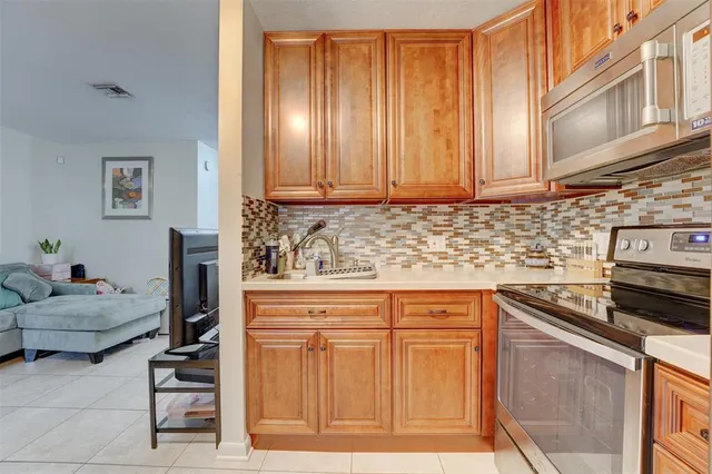 a kitchen with stainless steel appliances granite countertop a cabinets and a refrigerator