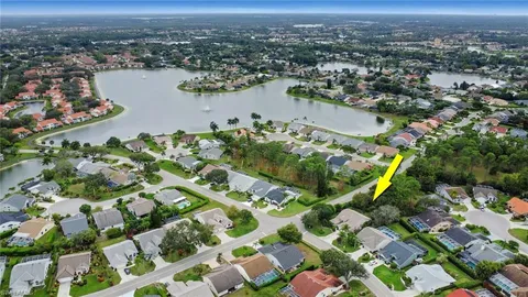 an aerial view of lake and residential houses with outdoor space