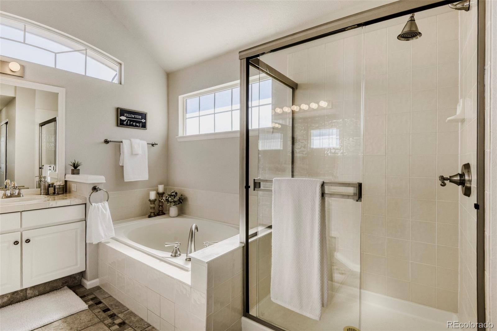 8573 South Mallard Court Highlands Ranch, CO 80126 - Photo 22 of 50 a bathroom with a tub a sink and mirror