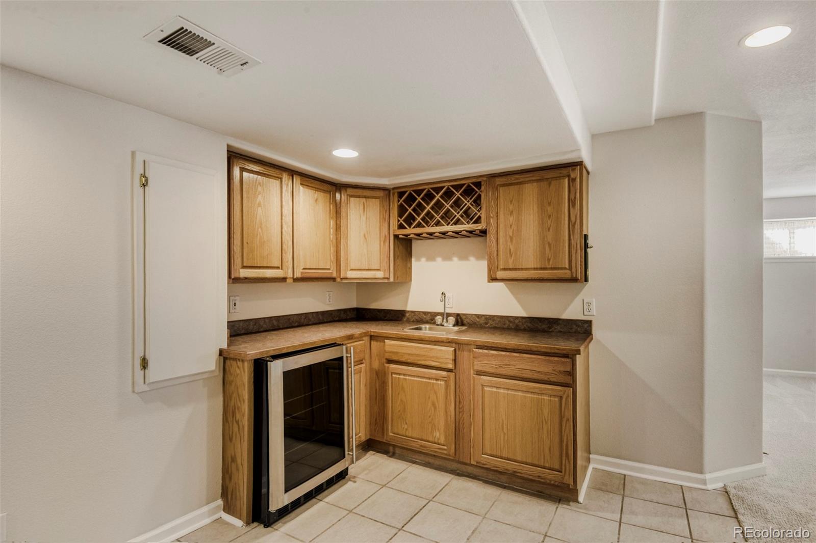 8573 South Mallard Court Highlands Ranch, CO 80126 - Photo 27 of 50 a kitchen with white cabinets and white appliances