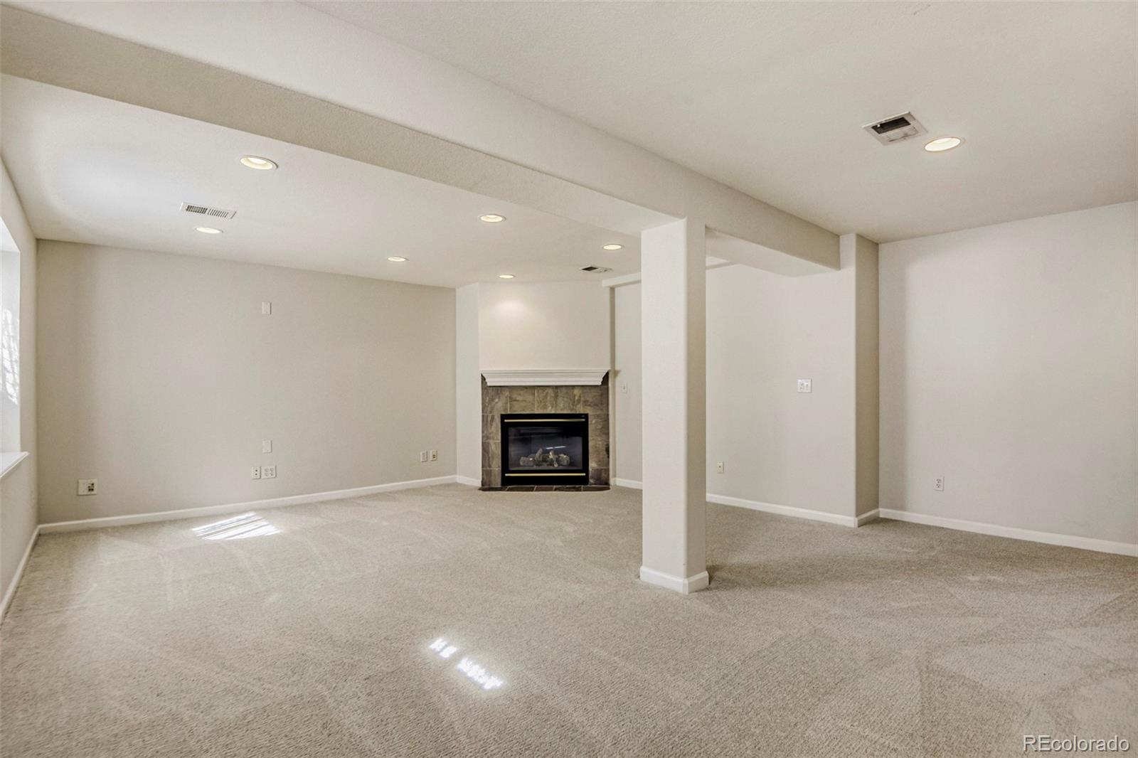 8573 South Mallard Court Highlands Ranch, CO 80126 - Photo 29 of 50 an empty room with fireplace
