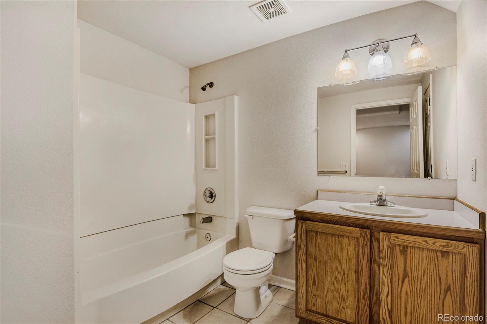 8573 South Mallard Court Highlands Ranch, CO 80126 - Photo 32 of 50 a bathroom with a sink toilet and shower