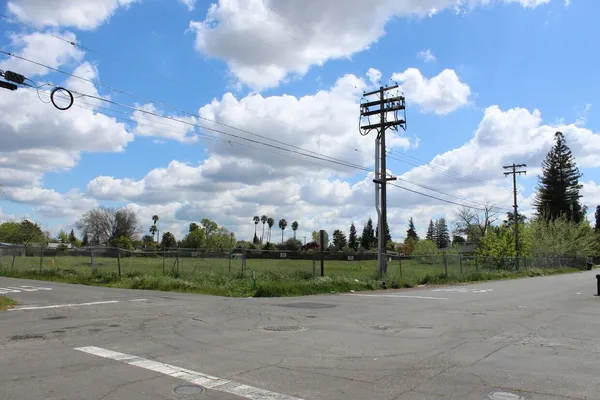 a street view with a building in the background