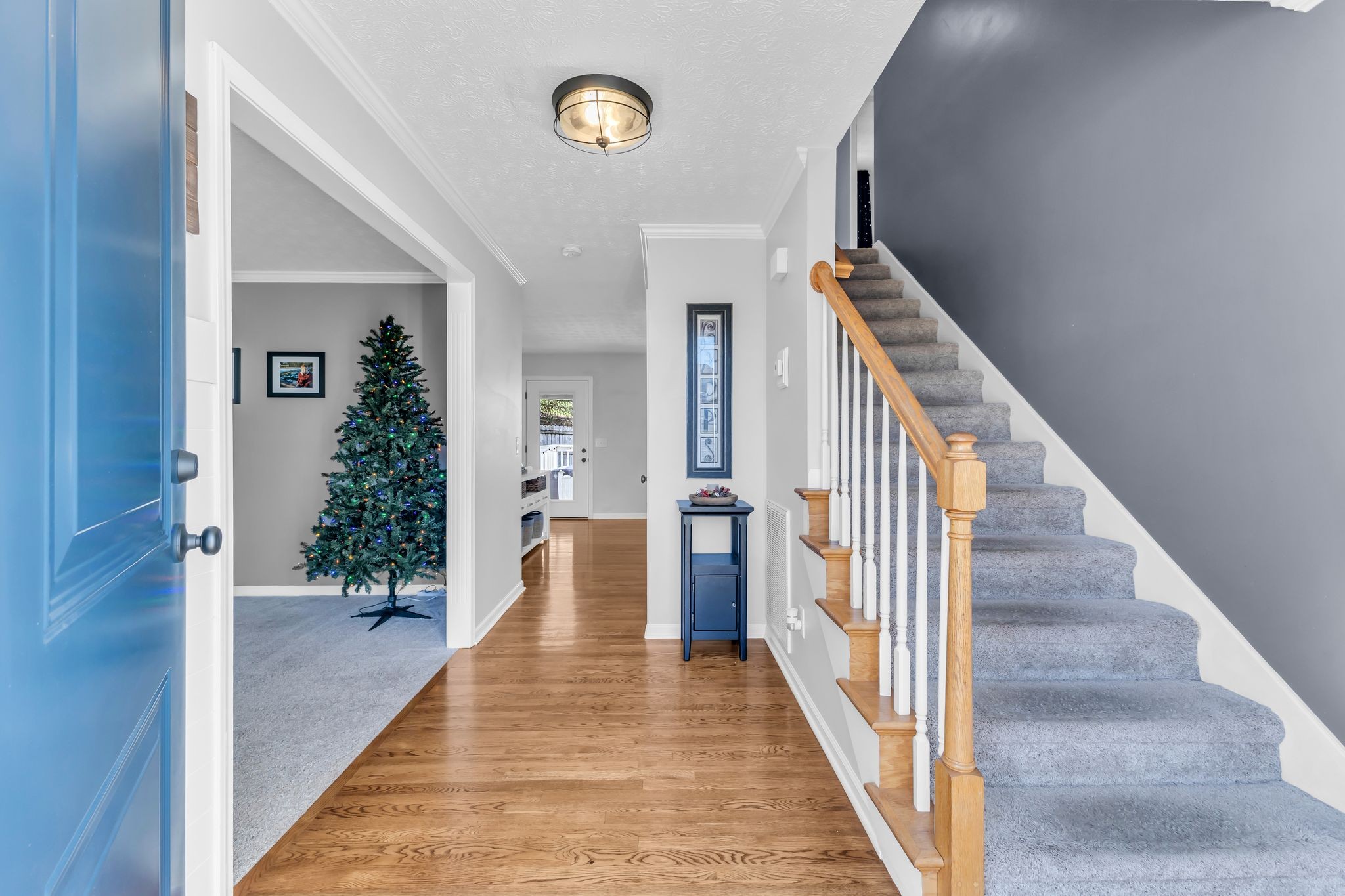 2005 Trenton Drive Spring Hill, TN 37174 - Photo 14 of 35 a view of a hallway with wooden floor and staircase