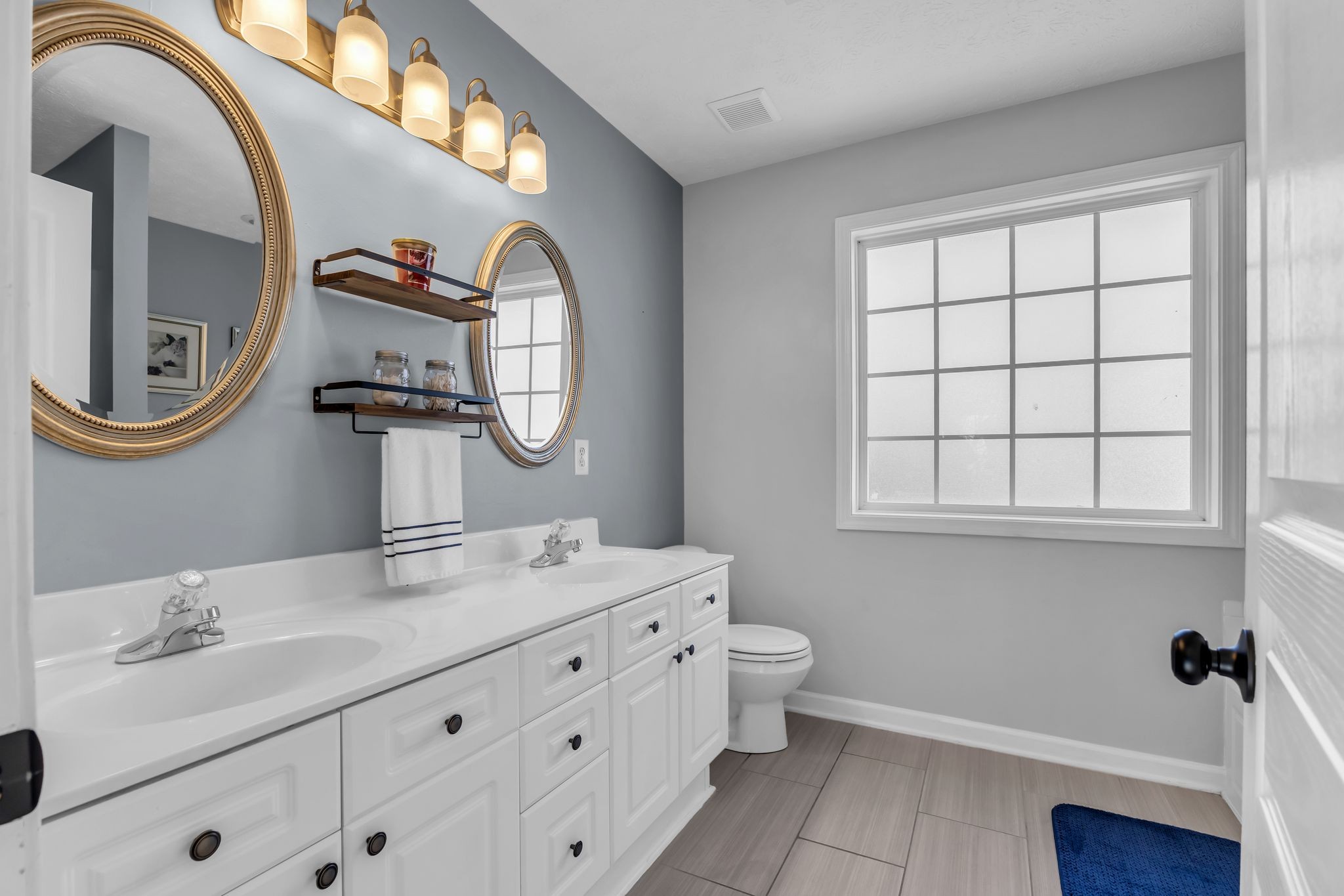 2005 Trenton Drive Spring Hill, TN 37174 - Photo 22 of 35 a bathroom with a double vanity sink and a mirror