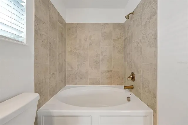 a bathroom with a white bath tub and a shower curtain