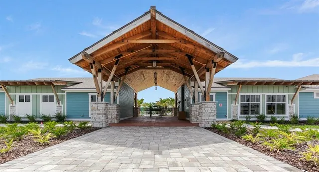 a view of a tables and chairs under an umbrella in the patio
