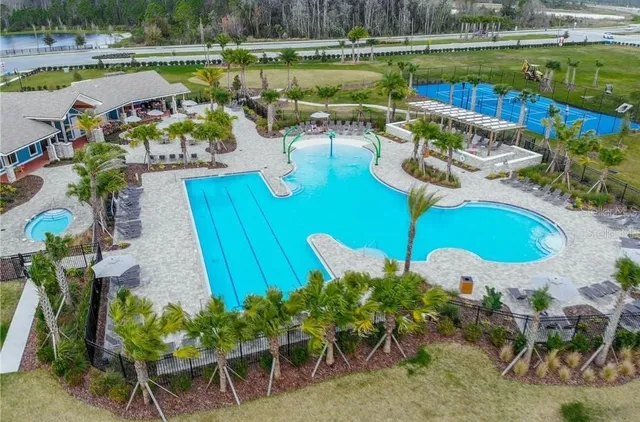 a view of a swimming pool with a patio and a garden