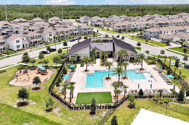 an aerial view of residential houses with outdoor space