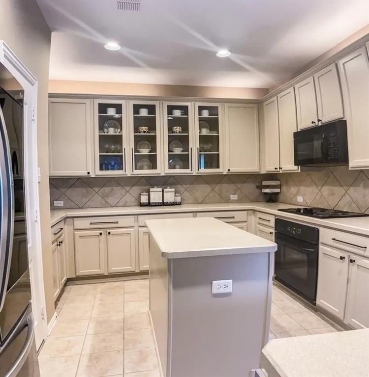 1391 Riverside Oaks Drive Rockwall, TX 75087 - Photo 11 of 32 a kitchen with stainless steel appliances granite countertop a stove sink and cabinets
