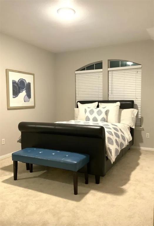 1391 Riverside Oaks Drive Rockwall, TX 75087 - Photo 17 of 32 a bedroom with bed and a couch