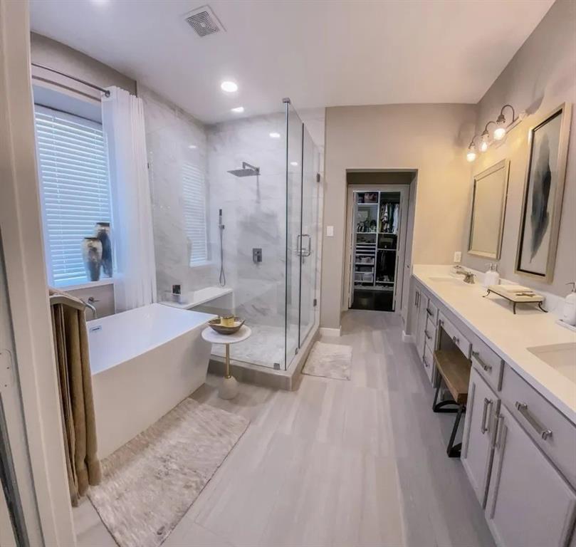 1391 Riverside Oaks Drive Rockwall, TX 75087 - Photo 22 of 32 a bathroom with a tub sink double vanity granite tub shower and mirror