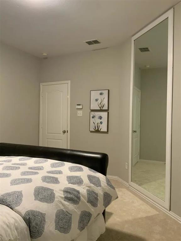 1391 Riverside Oaks Drive Rockwall, TX 75087 - Photo 28 of 32 a bedroom with a bed and a painting on the wall