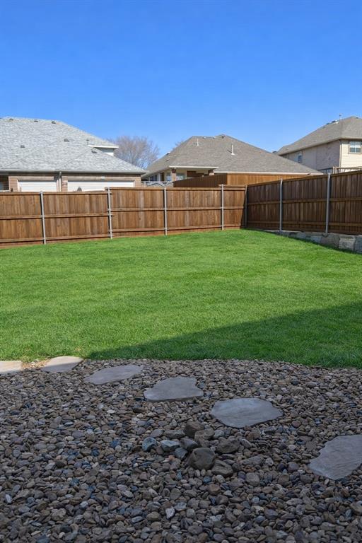 1391 Riverside Oaks Drive Rockwall, TX 75087 - Photo 31 of 32 a view of a big yard with a large tree in the background