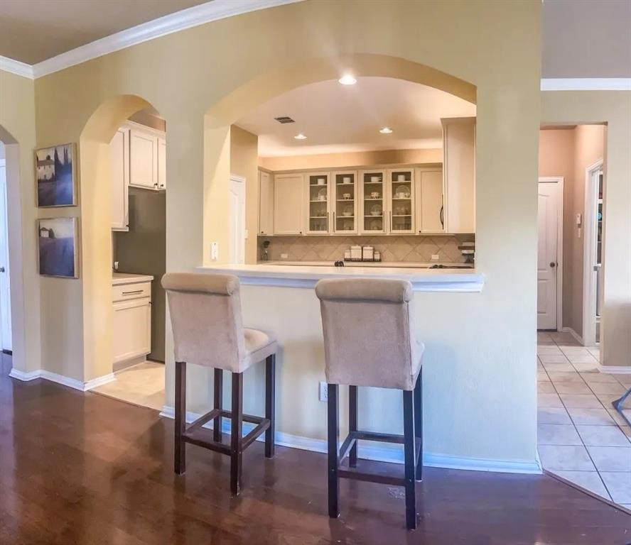 1391 Riverside Oaks Drive Rockwall, TX 75087 - Photo 9 of 32 a kitchen with a table chairs refrigerator and cabinets