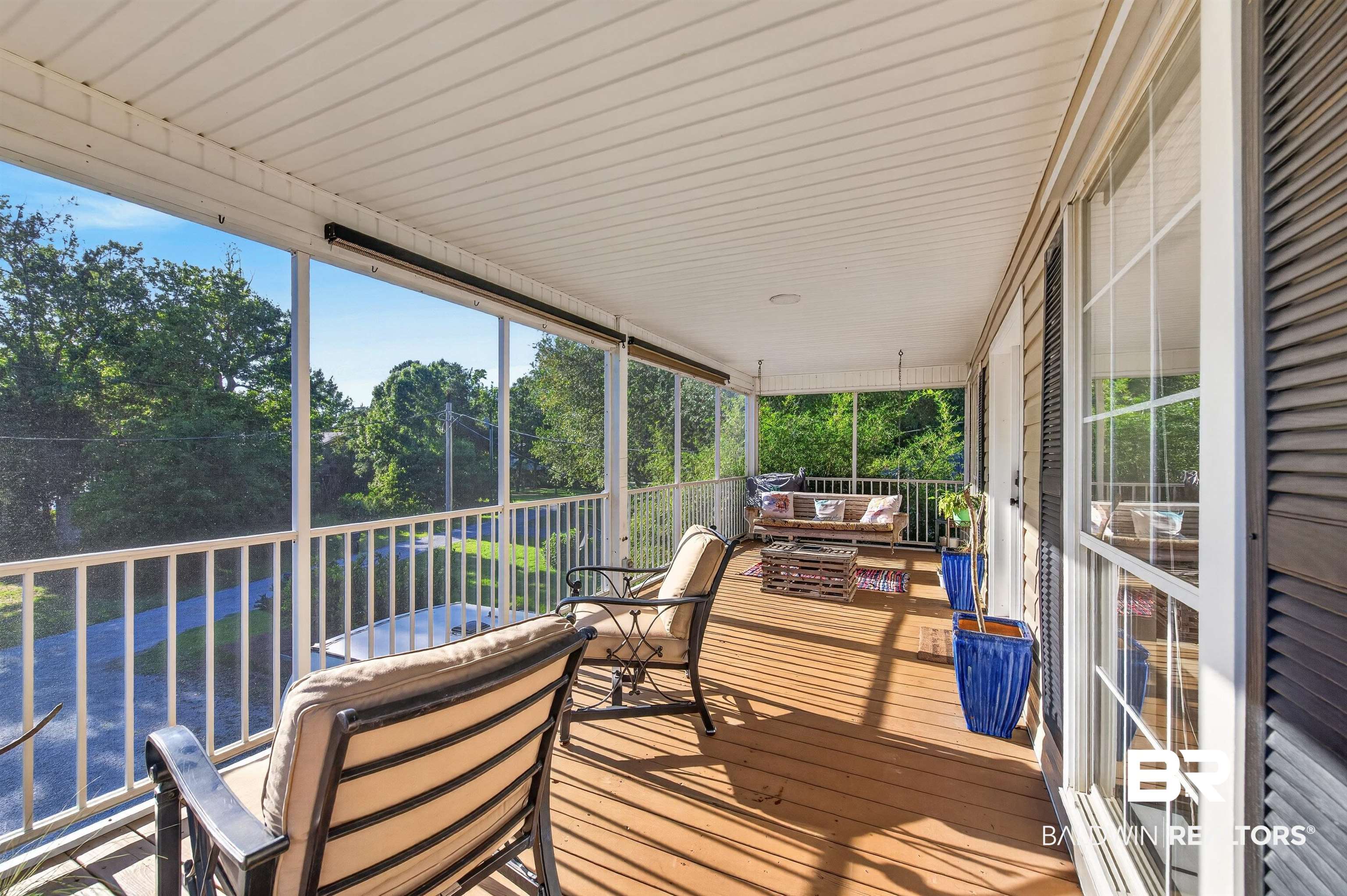 9624 North Bay Street Foley, AL 36535 - Photo 35 of 59 Expansive screened porch featuring wood-finish flooring, white railing, and a white beadboard ceiling