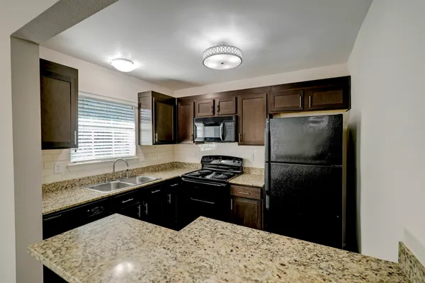 a kitchen with a refrigerator and a sink