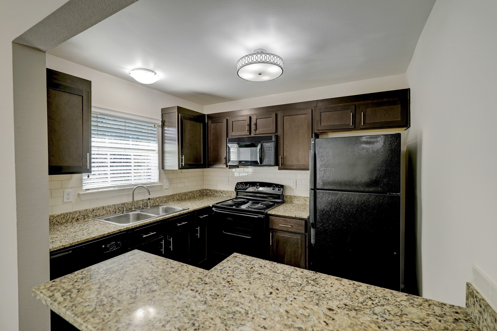a kitchen with a refrigerator and a sink