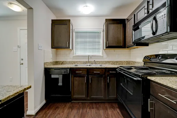 a kitchen with stainless steel appliances granite countertop a stove and a sink