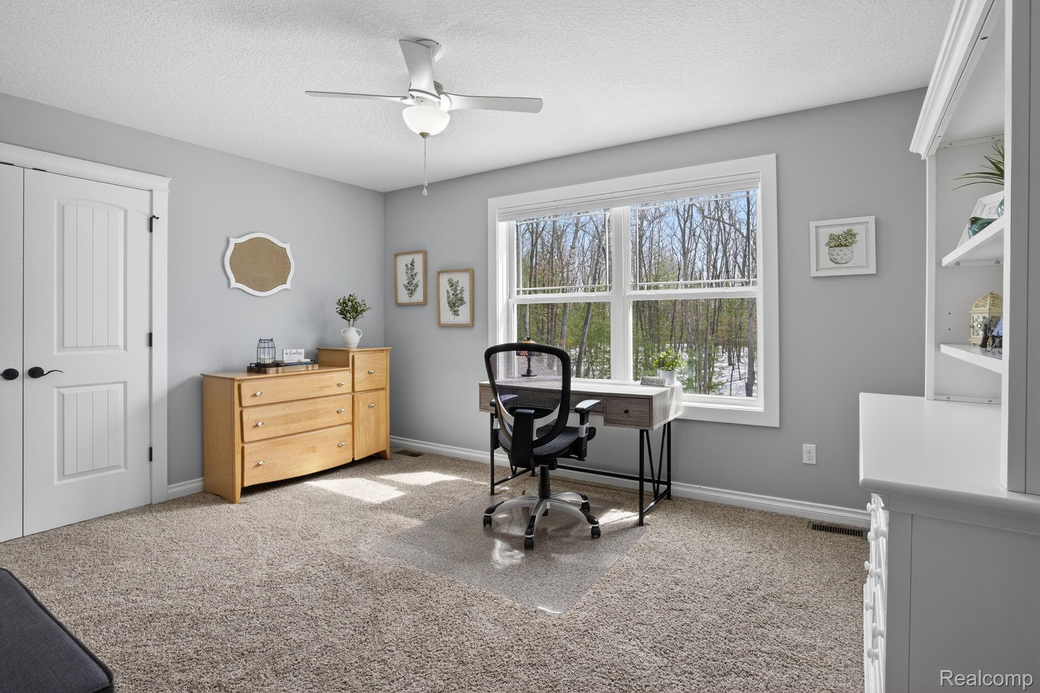 101 Highview Road Traverse City, MI 49696 - Photo 56 of 88 Office area with light carpet, ceiling fan, and a textured ceiling