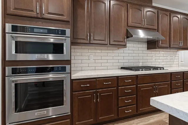 a kitchen with granite countertop stainless steel appliances and cabinets