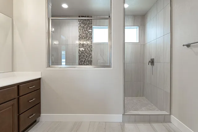 a bathroom with a shower and a sink