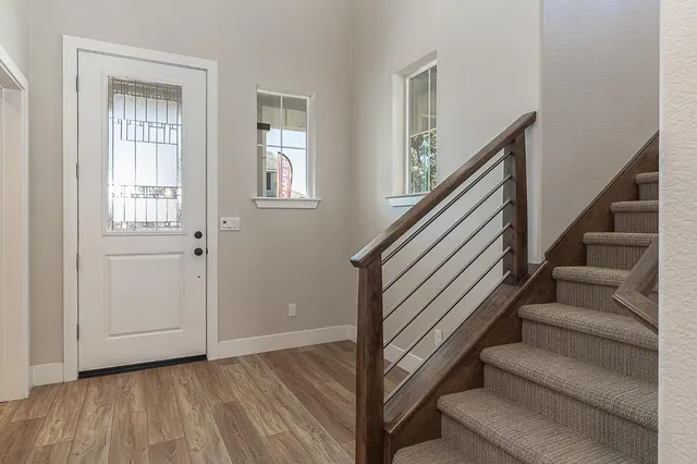a view of entryway and hall with wooden floor