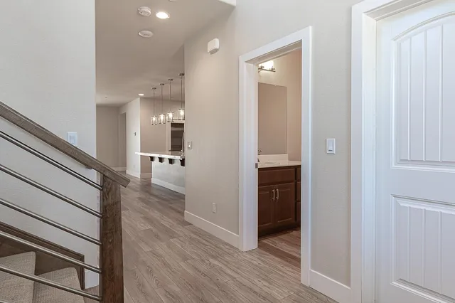 a view of a hallway with wooden floor