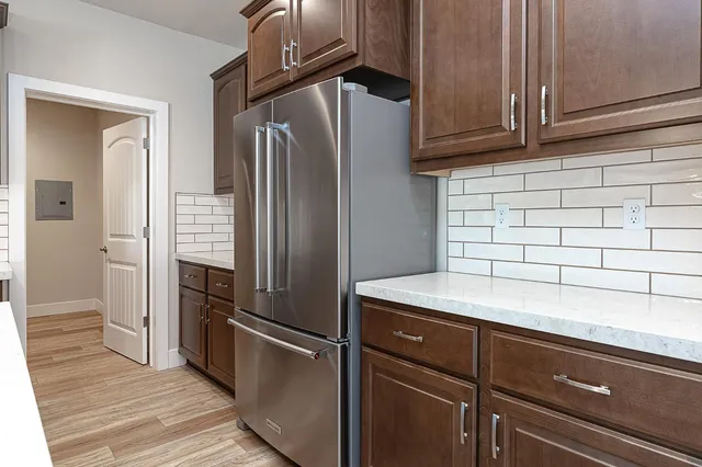 a kitchen with a refrigerator and cabinets