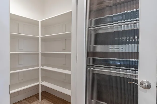 a view of walk in closet with empty racks
