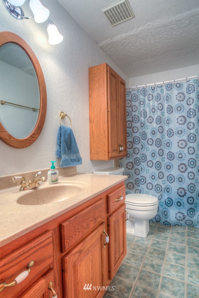 2833 Morris Avenue South Renton, WA 98055 - Photo 12 of 16 a bathroom with a sink a toilet and a mirror