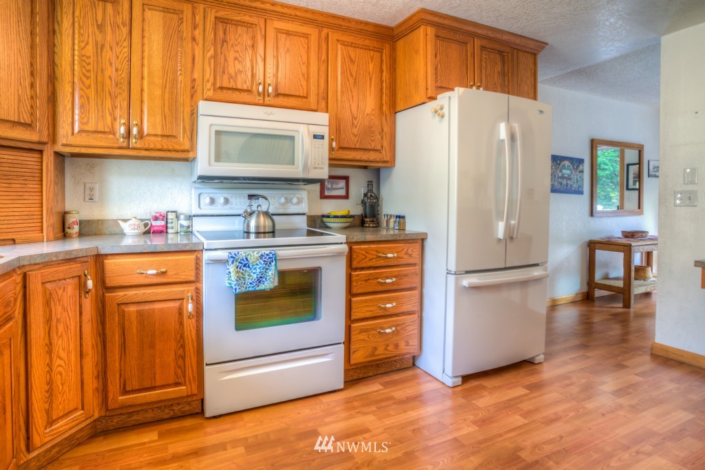 2833 Morris Avenue South Renton, WA 98055 - Photo 8 of 16 a kitchen with stainless steel appliances a refrigerator stove and cabinets