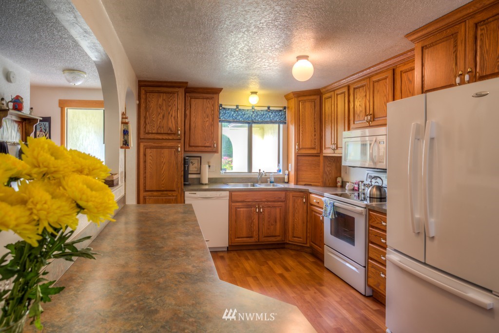 2833 Morris Avenue South Renton, WA 98055 - Photo 9 of 16 a kitchen with granite countertop a refrigerator a sink dishwasher stove and oven