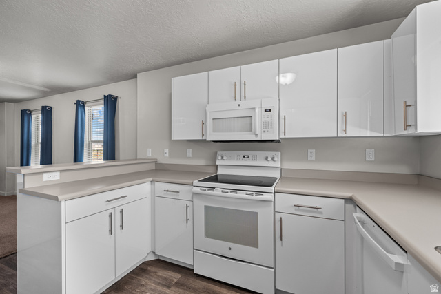 1700 South Sandhill Road West, Unit E 301 Orem, UT 84058 - Photo 9 of 20 Contemporary kitchen featuring white cabinetry with brushed nickel hardware, laminate countertops, a white electric range, and an over-the-range microwave