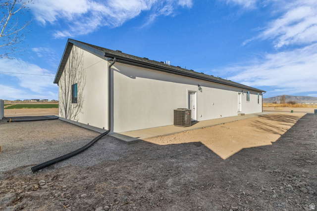 520 East 450th Street North Delta, UT 84624 - Photo 7 of 48 Back of house featuring a mountain view and stucco siding