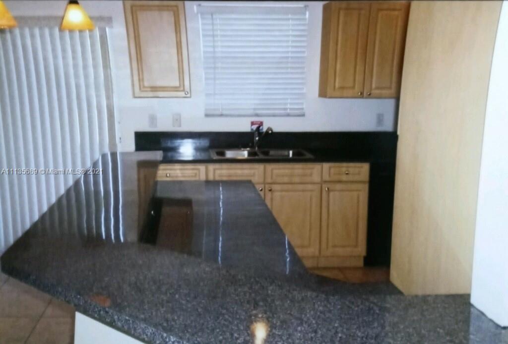 3973-3975 Sunset Road Lehigh Acres, FL 33971 - Photo 11 of 14 a bathroom with a sink and a mirror