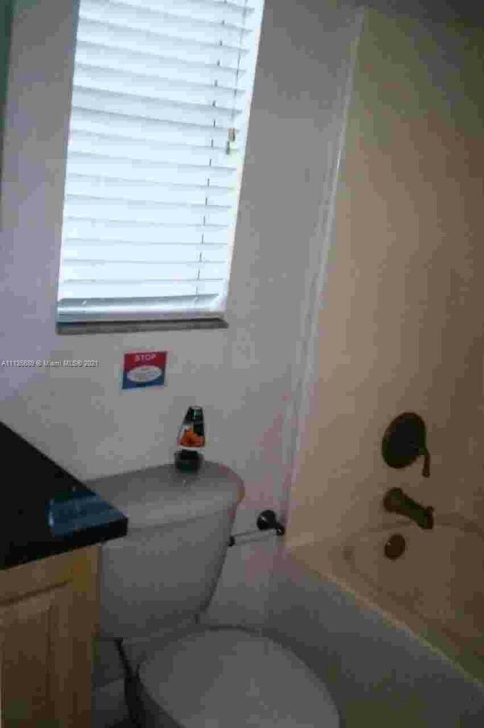 3973-3975 Sunset Road Lehigh Acres, FL 33971 - Photo 13 of 14 a bathroom with a sink and a shower