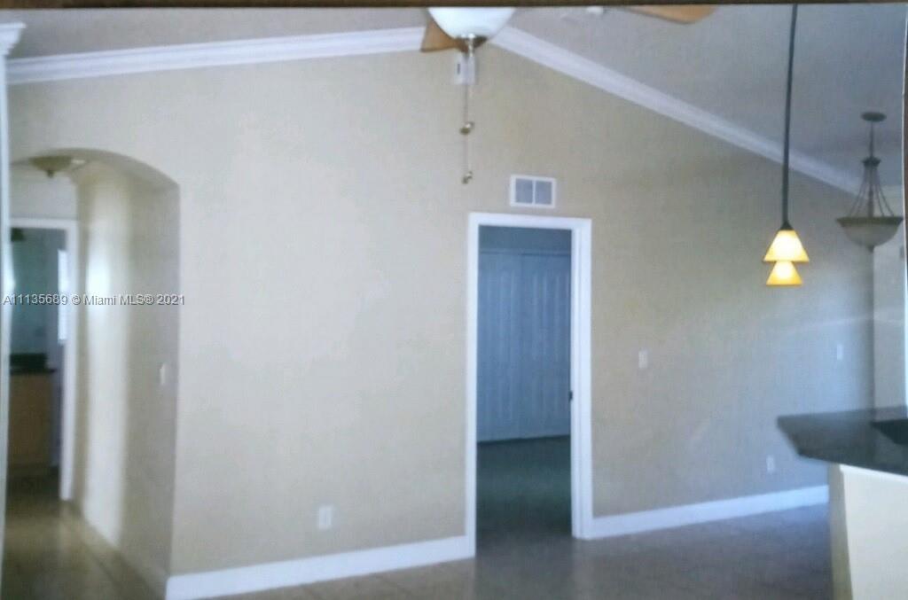 3973-3975 Sunset Road Lehigh Acres, FL 33971 - Photo 7 of 14 a bathroom with a light fixture and a shower