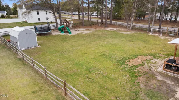 a view of a house with swimming pool and a yard