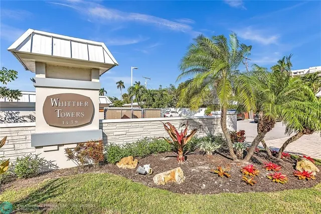 a backyard of a house with a table and chairs
