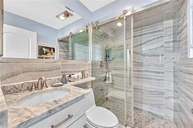 a bathroom with a sink toilet and shower