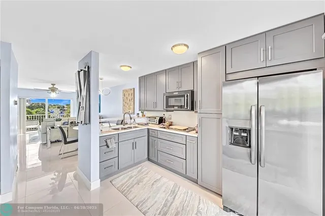 a kitchen with stainless steel appliances a refrigerator sink and cabinets