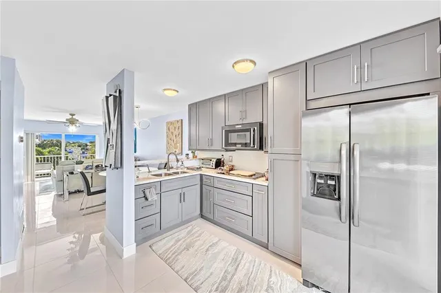 a kitchen with a sink refrigerator and cabinets
