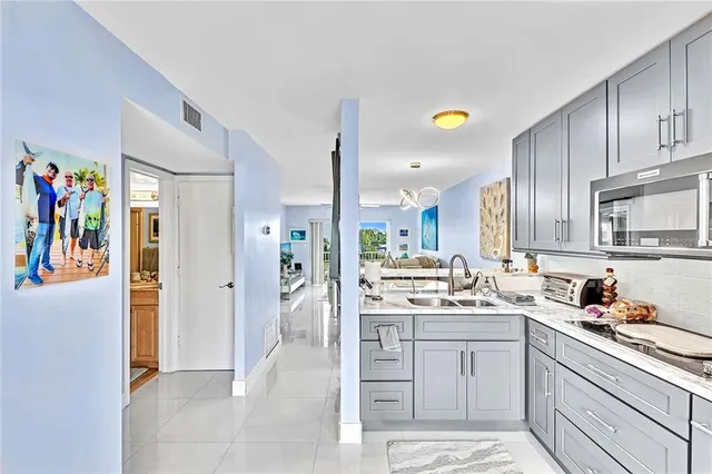 a kitchen with a sink and refrigerator