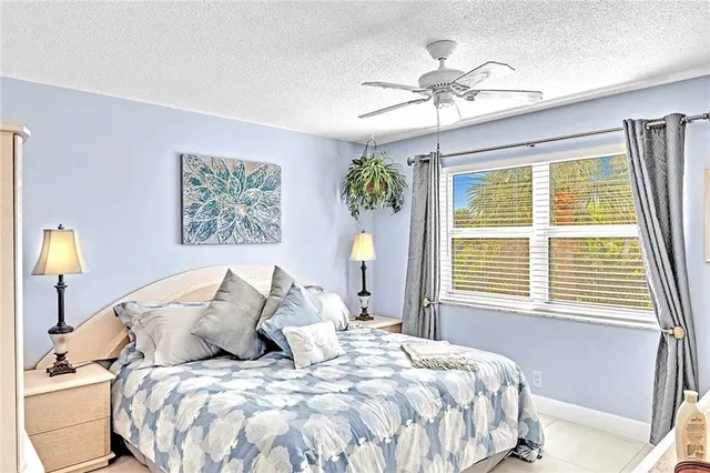 a bedroom with a bed dresser and a window