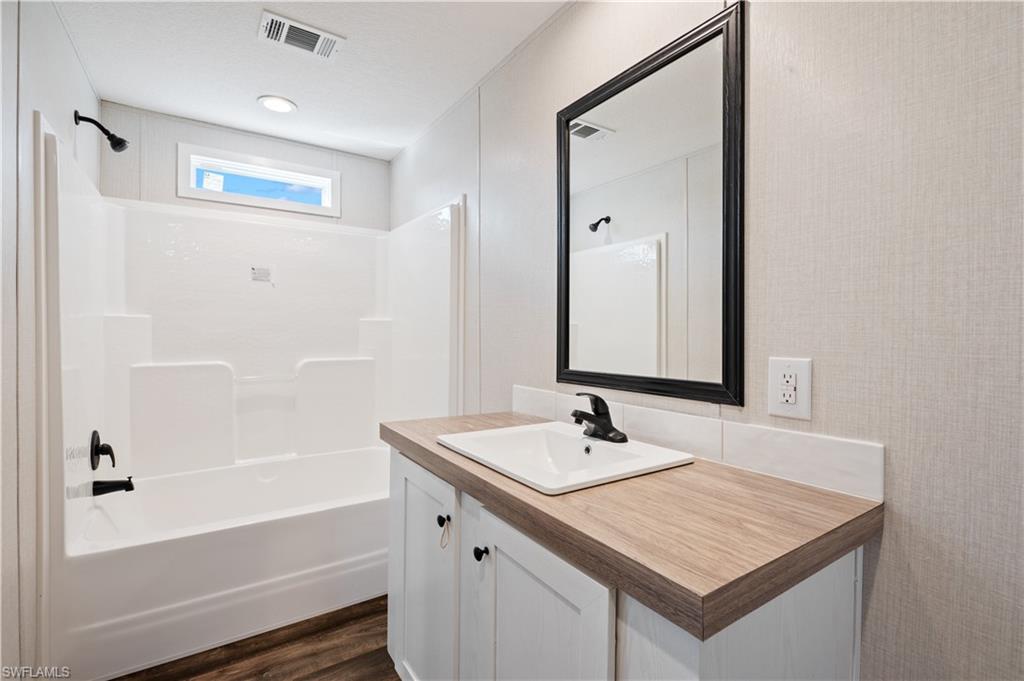 325 North Sendero Street Clewiston, FL 33440 - Photo 7 of 10 a bathroom with a sink and a mirror