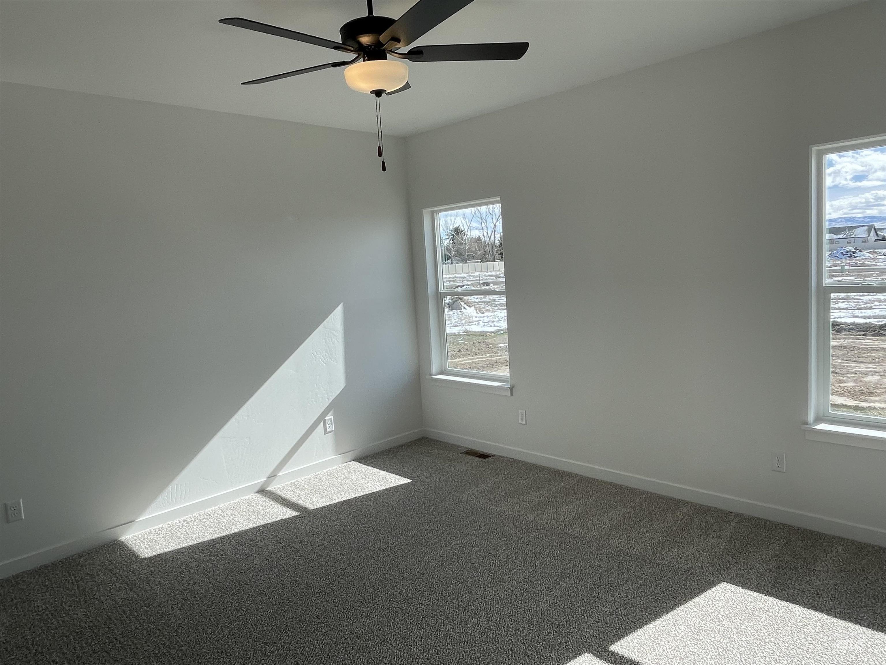 917 Quartz Road Kimberly, ID 83341 - Photo 9 of 12 Empty room with carpet floors and ceiling fan