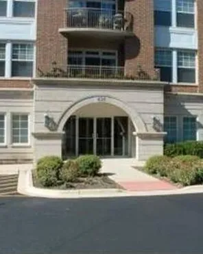 a front view of a building with a garden
