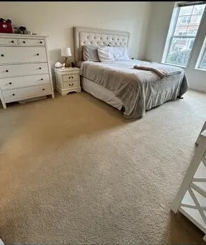 a bedroom with a bed and dresser