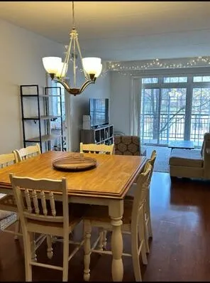 a dining room with a table chairs and a chandelier